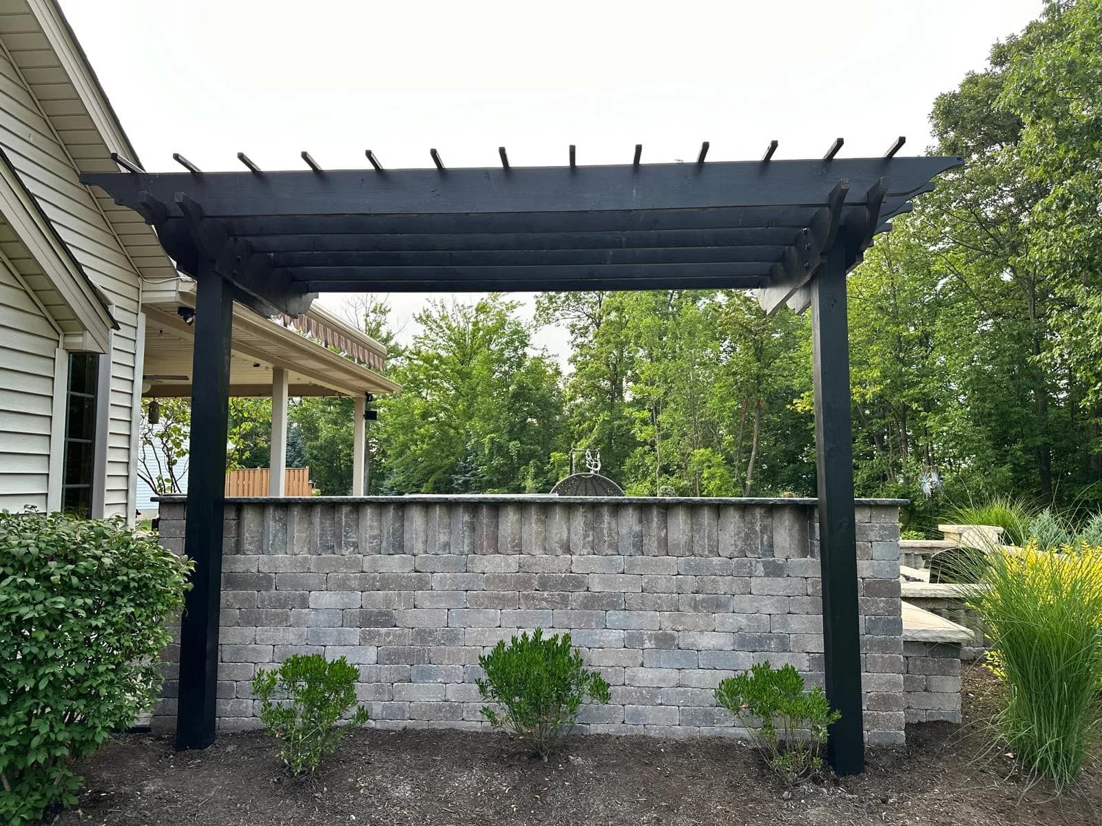Black aluminum pergola over patio — Buffalo NY