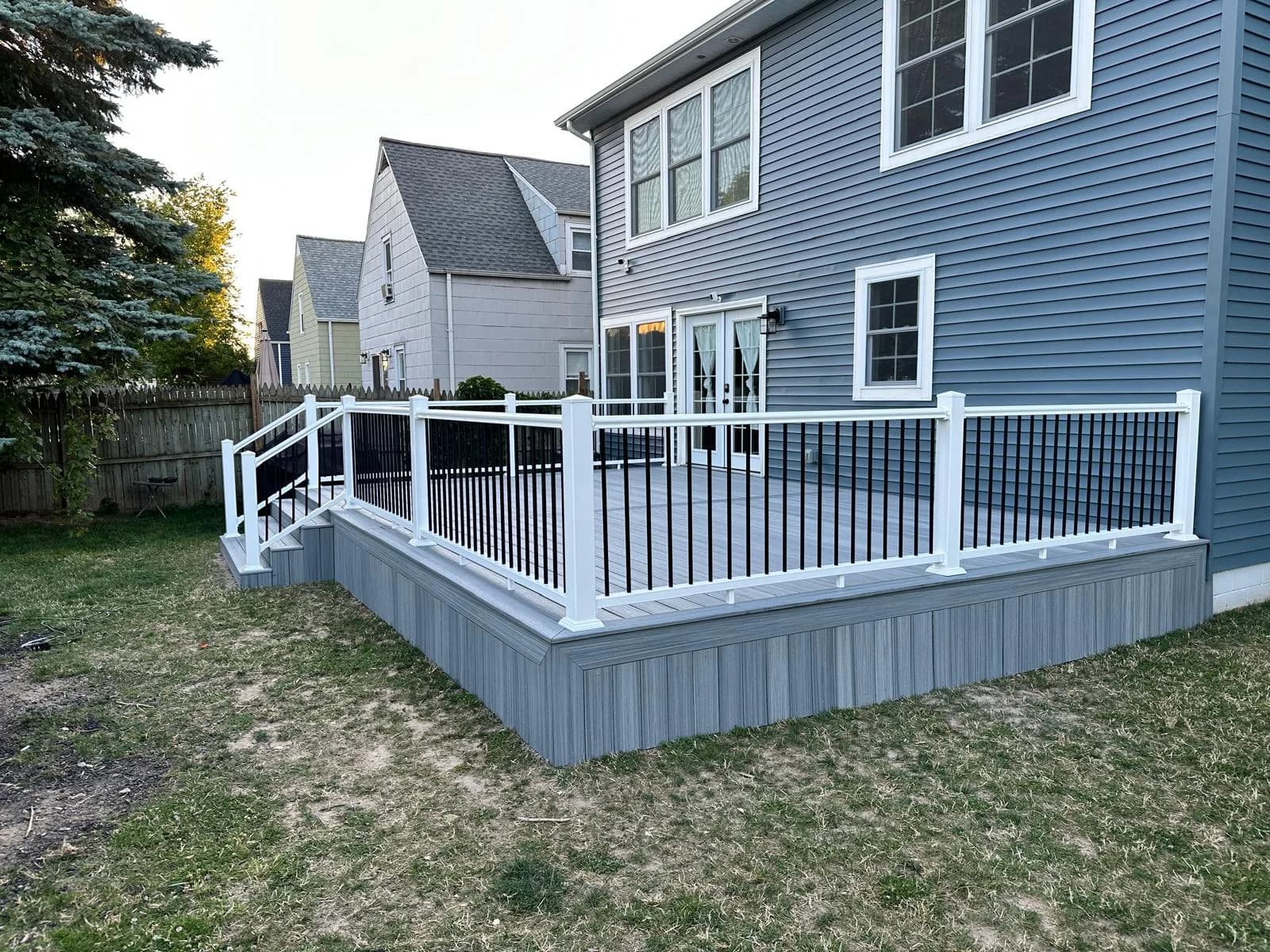 Completed multi-level composite deck with black railings — Buffalo NY