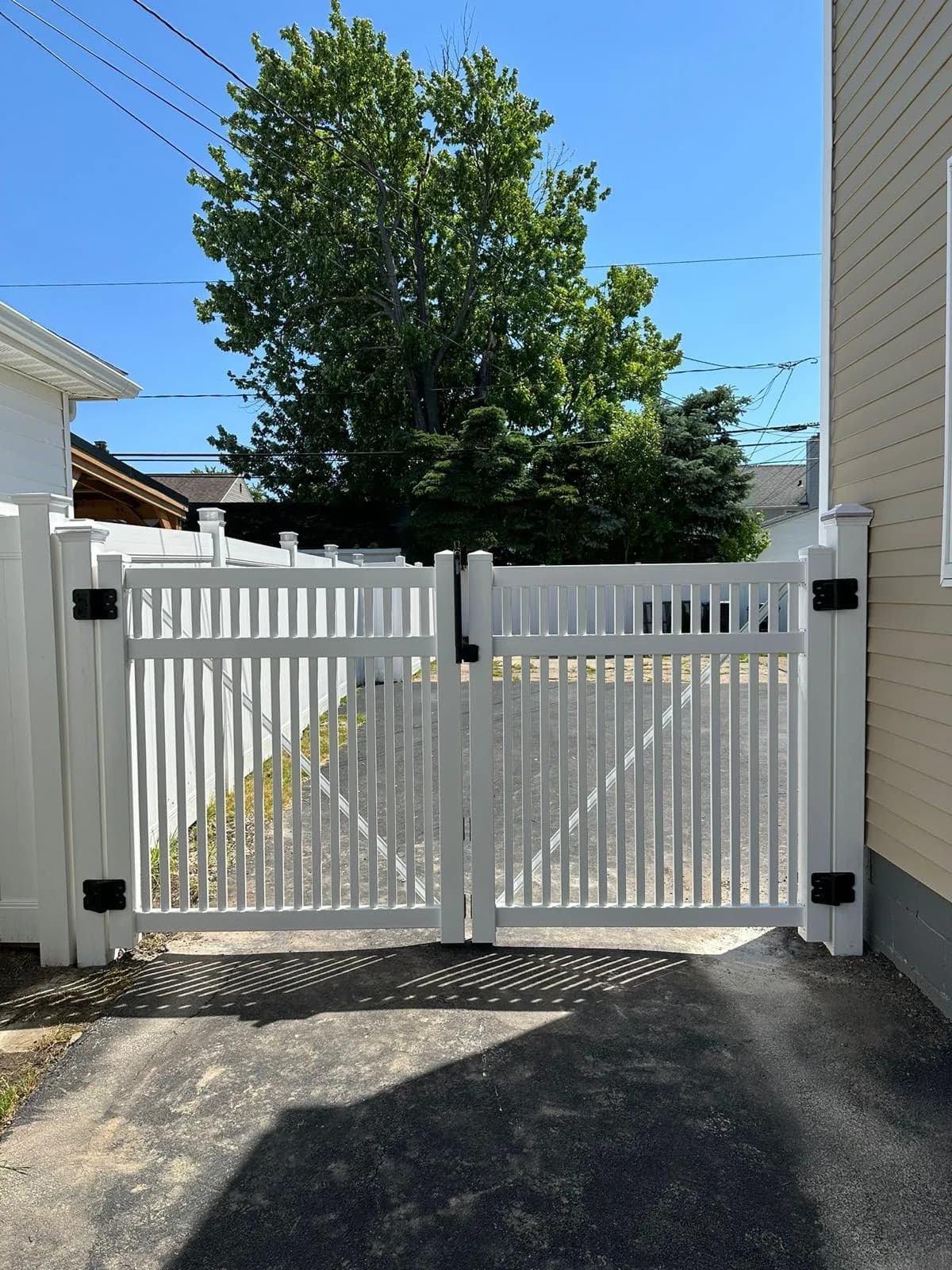 White vinyl driveway gate — Buffalo NY